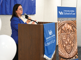 Zoom image: Stephanie A. Mack &rsquo;08, executive director of the Law Alumni Association, welcomes guests. 