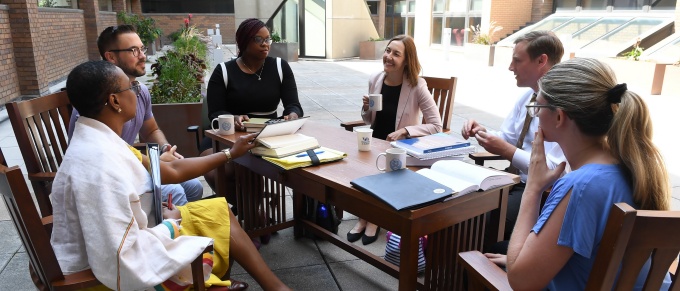 UB Law clinic students working at a table on the patio. 