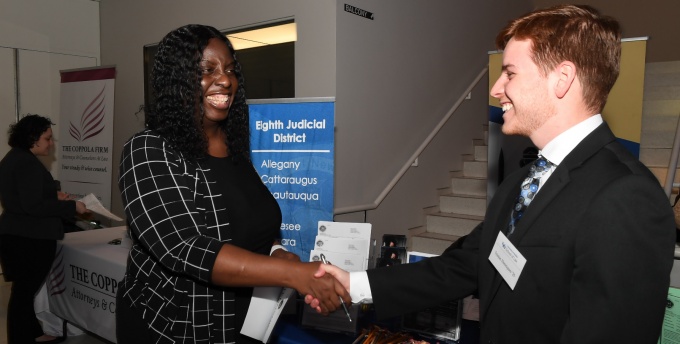 Student and employer engaging at a career fair. 