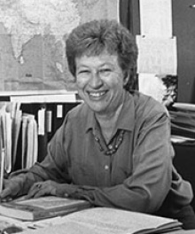 Leary smiling while sitting at her desk. 