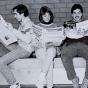 photo of students reading a newspaper. 