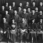 Black and white historical group photograph of law graduates wearing academic gowns, arranged in several rows. 