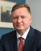 man in an office wearing red tie. 