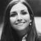 black and white photo of a woman smiling.