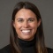 photo of a woman wearing black sweater, smiling.