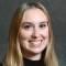 Krystin Wasser wearing black sweater, smiling. 