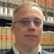 man standing in front of law books. 