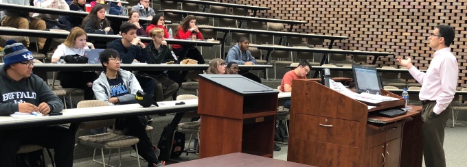 Photo of Professor Gardner teaching a classroom of undergraduate students. 