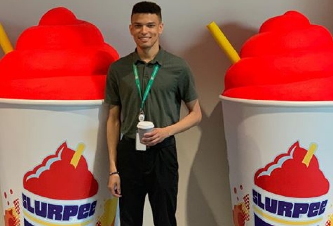 Williams standing between two Slurpie displays. 