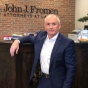 John J. Fromen Jr. &rsquo;87 in front of the reception desk at his practice. 