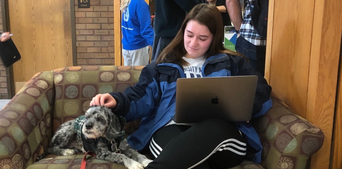 law student sitting with a dog. 