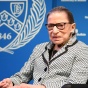 photo of Ginsburg sitting on stage. 
