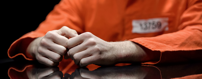photo of inmate sitting with his hands on the table. 