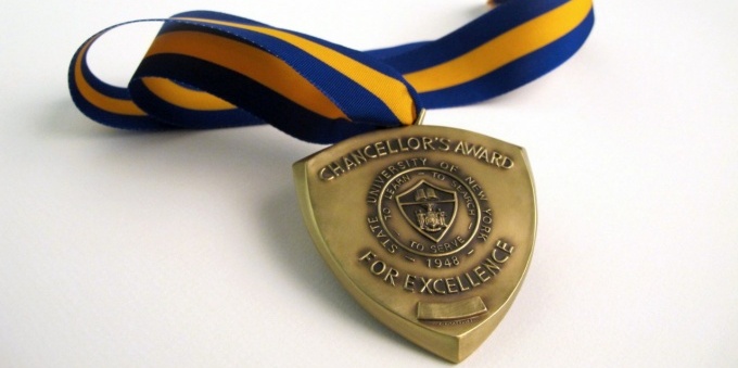 photo of the SUNY Awards medal on a white tabletop. 
