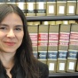 samantha barbas standing in the library in front of books. 