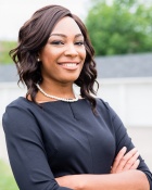 Tolulope Odunsi standing outside with her arms folded. 