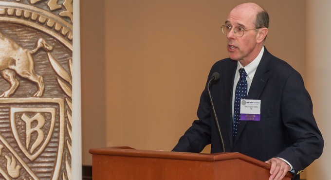 Fahey speaking at a podium. 