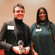 Kevin Hartnett '21 standing next to Shakierah Smith '22 while holding his DEI Ally Award. 