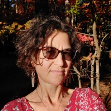 woman wearing sunglasses standing outside. 