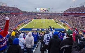 photo of a Bulls game taken in a stadium full of fans watching the game. 