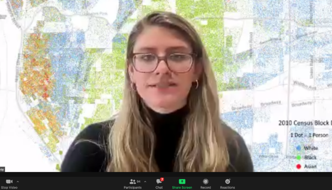 screen shot of law student on a Zoom conference call standing in front of a large map. 