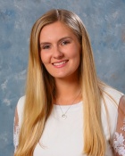 young woman with blonde hair posing for her portrait photo. 