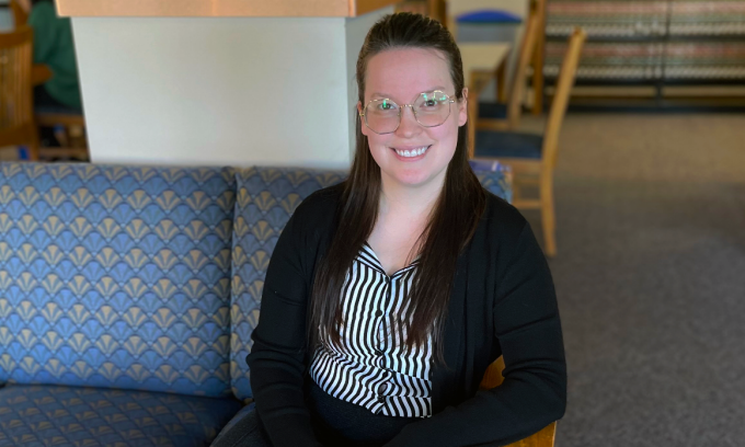 woman sitting on a sofa inside the library. 