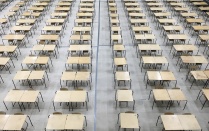 room with several tables and chairs lined up in several rows. 