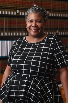 Newell standing inside the law library. 