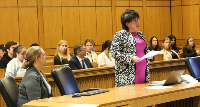 attorney attending court with students observing. 