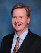 portrait photo of a man smiling. 