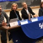 Chiesa sitting at a long table with additional faculty, conducting a panel discussion in a classroom. 