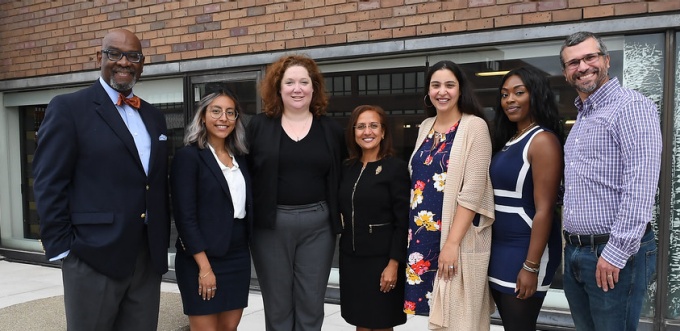 group of law school faculty and students standing for a photo outside. 