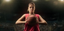 woman holding a basketball. 