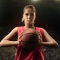 woman holding a basketball. 