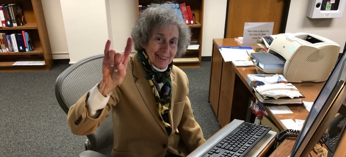 Zubrow sitting at her desk. 