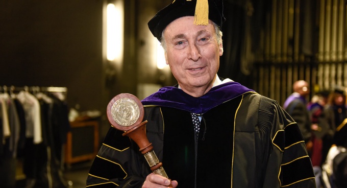 man wearing commencement regalia. 