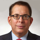 man wearing business suit and wearing glasses. 
