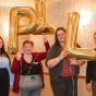 students holding up balloons that spell BPILP. 