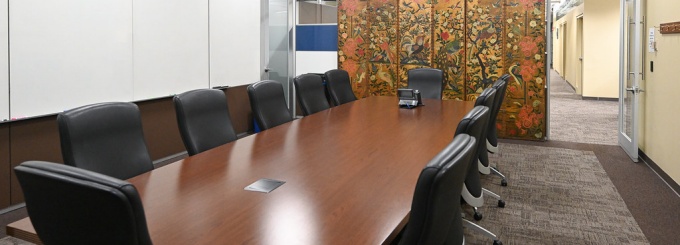 room with long board table and chairs. 