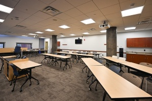 large room with long tables and chairs. 