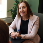 woman talking to student in an office. 