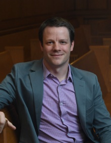 smiling man sitting on courtroom bench. 