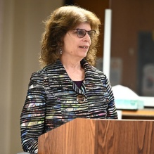 woman speaking at a podium. 