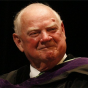 Joyce, smiling, wearing commencement regalia. 