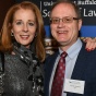 man and woman, smiling, attending a law school event. 