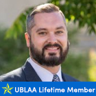 man outside, smiling, text that says UBLAA Lifetime Member. 