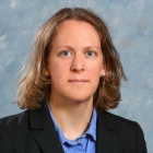 young woman wearing dark blazer. 