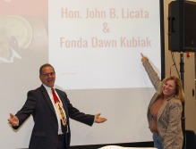 Man and woman standing in front of a projected image. 
