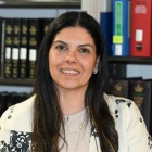 Woman sitting at a table in a law library. 